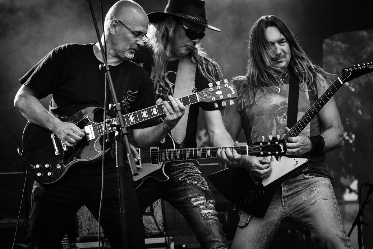 Live band performing on an outdoor stage in black and white
